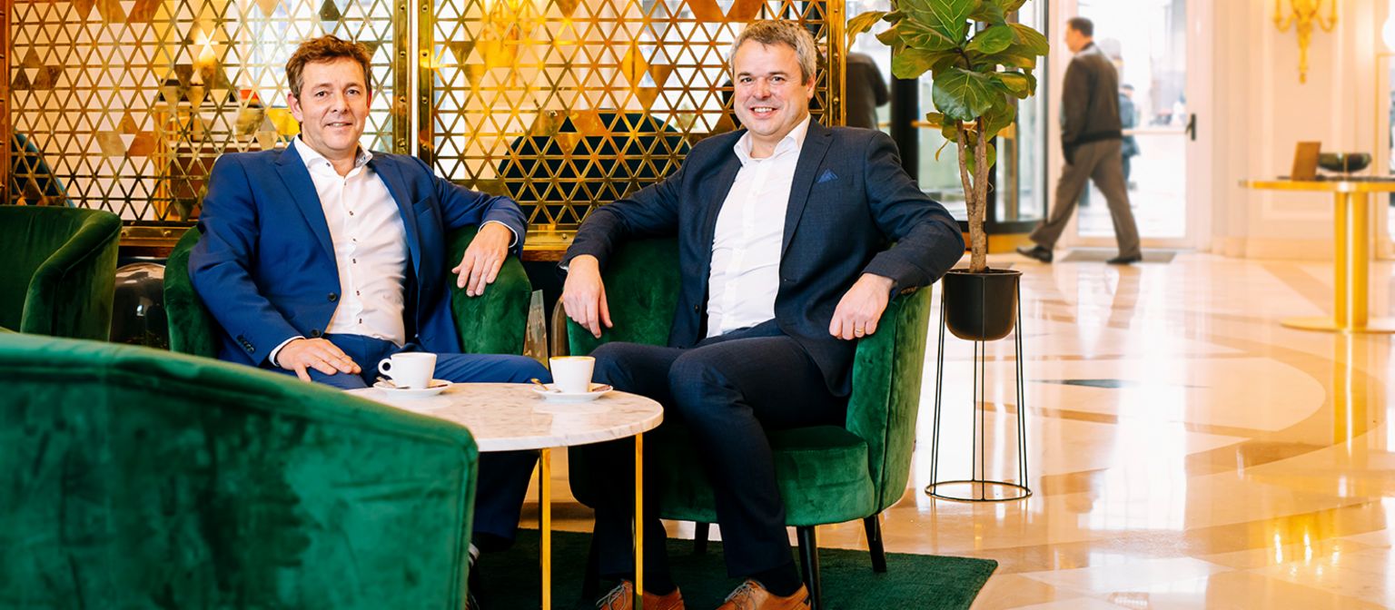 Roel Dumont und Ivan Demuynck sitzen bei einem Kaffee zusammen.