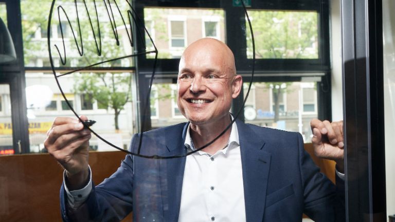 Andreas Behmenburg, Regional Sales Manager bei EOS in Deutschland, skizziert ein Tortendiagramm auf einer Glaswand