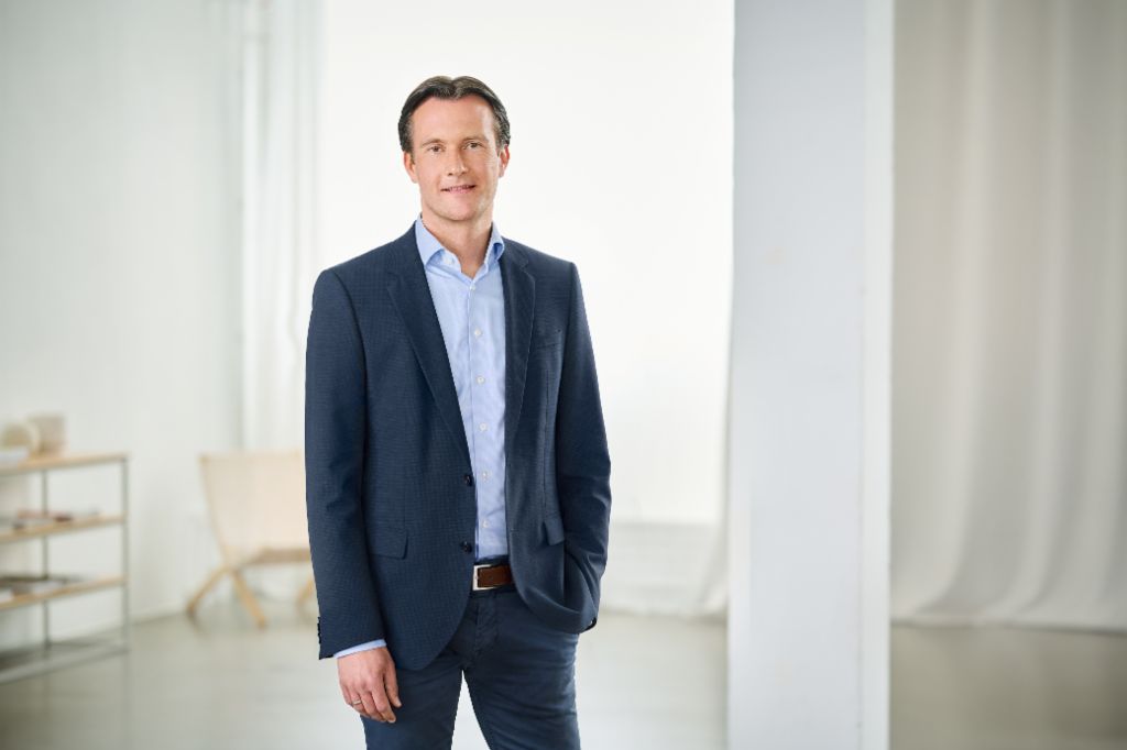 Carsten Tidow standing in a bright room